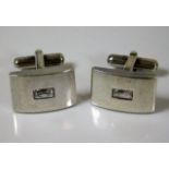 A pair of silver cufflinks with simulated diamond