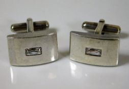 A pair of silver cufflinks with simulated diamond
