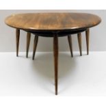 A nest of three retro Ercol elm pebble tables, lar