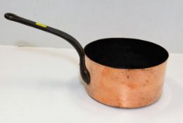 A 19thC. copper pan with iron handle 15.25in long