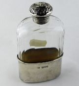 A faceted glass hip flask with silver cup & silver