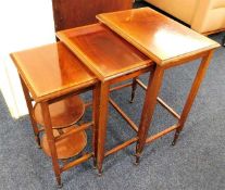 A mahogany next of tables with inlaid decor & smal