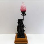 An oak mounted antique spelter figurative lamp wit