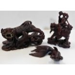 A carved Chinese fu lion dog twinned with two othe