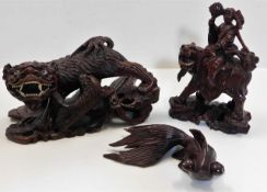 A carved Chinese fu lion dog twinned with two othe