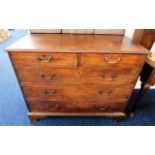 An oak George III chest of drawers with brass fitt