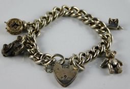 A silver charm bracelet with a small bear & clock