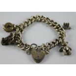 A silver charm bracelet with a small bear & clock