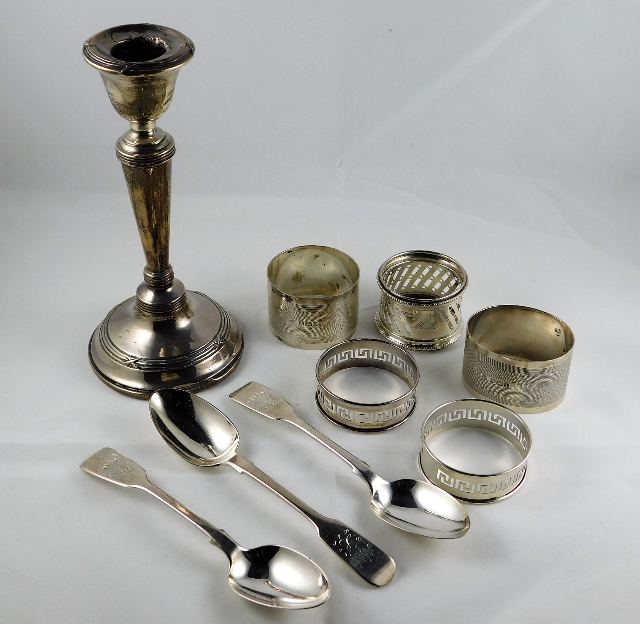 Three silver spoons twinned with five silver napki