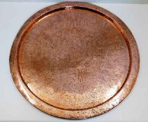 A large 19thC. copper tray of Islamic interest 23i