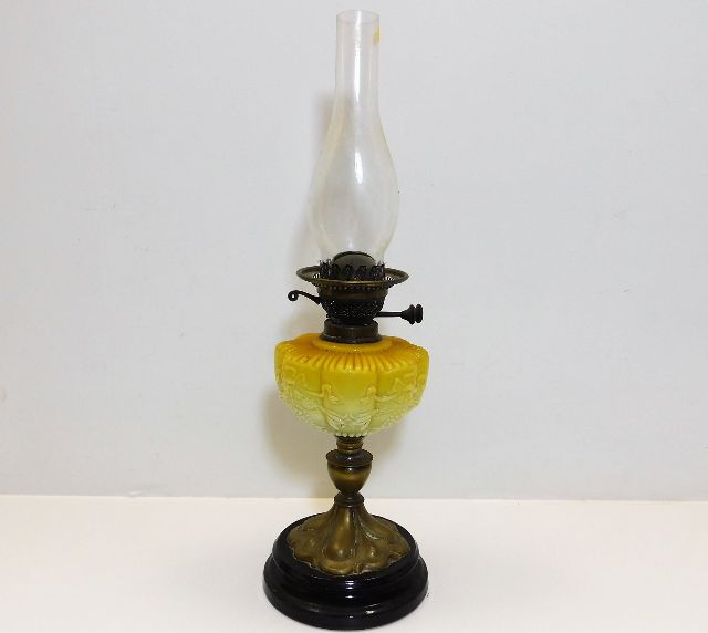 A Victorian oil lamp with glass opaline well 23.5i