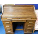 An oak roll top desk 48in wide x 46.5in high x 27.