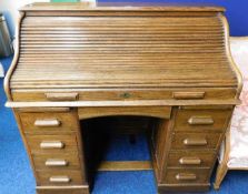 An oak roll top desk 48in wide x 46.5in high x 27.