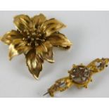 A floral 9ct gold brooch twinned with one other 7.
