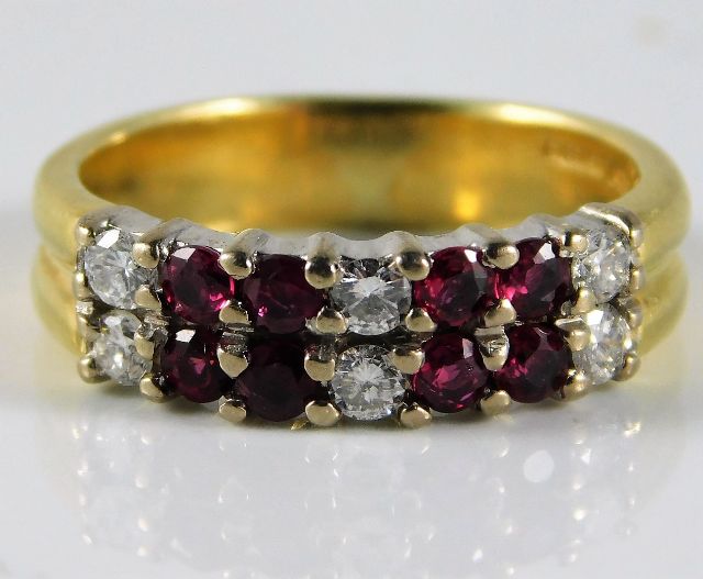 An 18ct diamond & ruby ring set with approx. 0.24ct diamond 5.4g size L/M