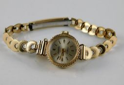 A 9ct gold cased wristwatch with a 10ct gold strap