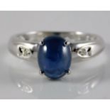 A 9ct white gold ring set with diamond & sapphire