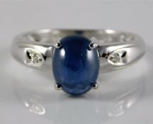 A 9ct white gold ring set with diamond & sapphire