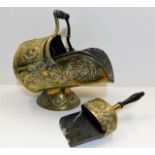 A decorative Victorian brass coal scuttle with mat