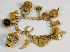 A 9ct gold charm bracelet, 10 x 9ct charms, 1 x 18