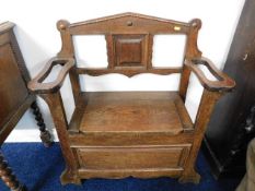 An arts & crafts style oak monks bench style stick