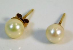 A pair of 9ct gold mounted pearl earrings, one lac