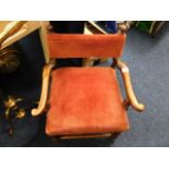 An antique low level childs upholstered chair