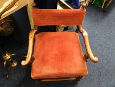 An antique low level childs upholstered chair