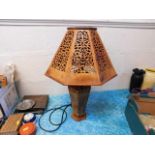 A decorative lamp with fretwork shade
