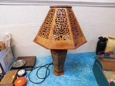 A decorative lamp with fretwork shade