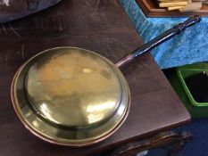 A brass bed warming pan