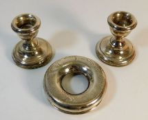 A pair of small silver candle holders twinned with