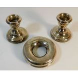 A pair of small silver candle holders twinned with