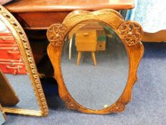 An oak mounted oval mirror