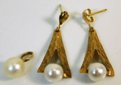 A pair of 9ct gold earrings set with pearl & a pea