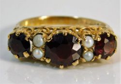 A 9ct gold ring set with garnet & pearl size O 2.7