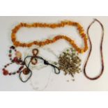 An agate necklace twinned with an amber necklace &