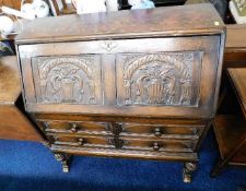 A 1920's carved oak bureau