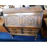 A 1920's carved oak bureau