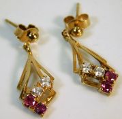 A pair of 9ct gold earrings with red & white stone