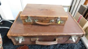 Two vintage suitcases twinned with a small blue shoe case