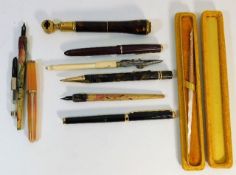 A Parker Slimfold fountain pen twinned with other