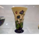 A modern Moorcroft pottery vase with floral decor