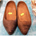 A pair of antique carved wooden shoes
