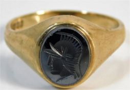 A 9ct gold ring with intaglio centurion carving, possibly hematite 6.4g size Y