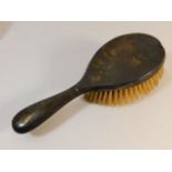 A silver backed hairbrush