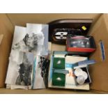 A box of sundry items including postcards which de