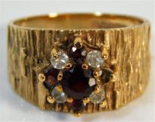 A 9ct gold garnet bark effect ring lacking stone s