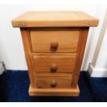 A chunky pine bedside cabinet