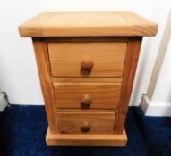 A chunky pine bedside cabinet